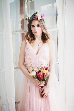 Perfect Woman Fashion Model in Pink Evening Gown and Flowers Wreath