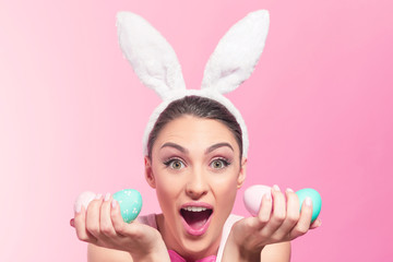 Excited bunny woman with easter eggs