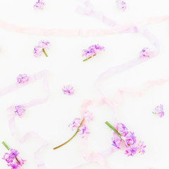 Pattern of pink hyacinth, petals and tapes on white background. Flat lay, top view.