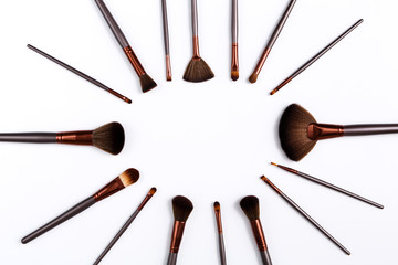 Cosmetics, beauty, make-up brushes set on white with copy space