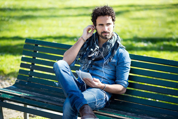 Man listening music outdoors