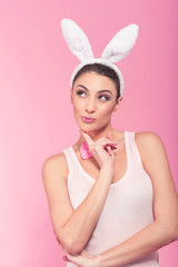 Obraz na płótnie Canvas Bunny-woman thinking about Easter