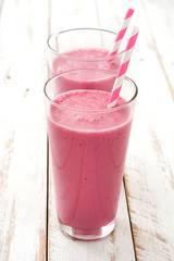 Raspberry smoothie on wooden table
