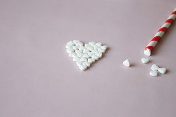 Fototapeta na wymiar Symbol heart from pills pink background