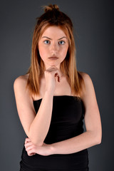 Fototapeta premium Young brunette lady posing on grey background