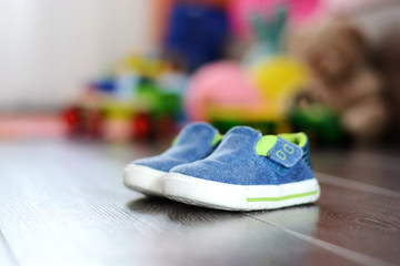 Blue tiny shoes on wooden floor