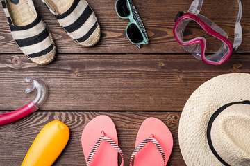 Summer or beach accessories on wooden table. Holiday background