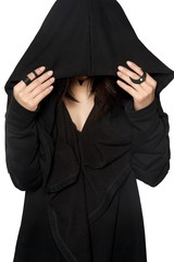 A girl in a black gown under a hood. Street fashion, gothic, hip-hop