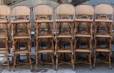 woven chairs stacked outside bamboo