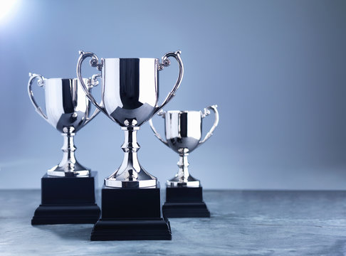 Still life of three trophies awaiting the winners' presentation