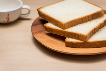 Fototapeta na wymiar Close-up of slice of toast bread on wood table