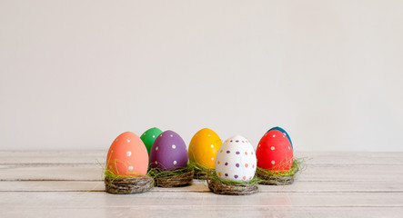 Easter eggs hand painted sitting in nests on white background. Happy Easter