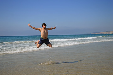 Happy man enjoying holiday on the beach in San Diego, California, USA	