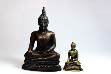 Two small earth touching Buddha figurines