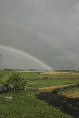 Double rainbow that ends in countryside