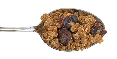 Organic cranberry nut granola on a spoon top view against a white background.
