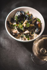 Mussels in Roquefort sauce  on the black stone background