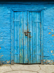 old barn wooden door with cracked paint