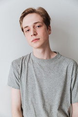 Vertical image of calm young man posing in studio