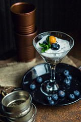 Healthy yogurt with blueberries, strawberries and cereals. Dessert. The restaurant or cafe atmosphere. Vintage