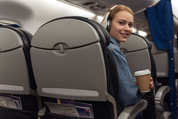 Cheerful woman traveling by plane