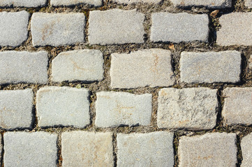 Tiled with paving stone bricks path's fragment as an abstract background