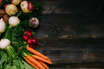 Organic vegetables background. Fresh harvested vegetables on the dark wooden background, top view, with copy space