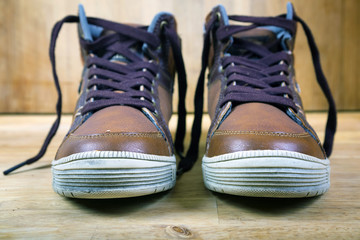 Pair of brown sneakers with laces