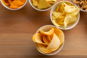 Pretzels in bowls on wooden table from above