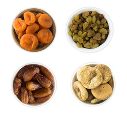 Collage of different dried fruits. Raisins, dates, dried apricots, figs isolated on white background. Top view.