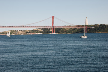 The Christ the King statue and 25 April bridge over the Tagus river in Lisbon, Portugal