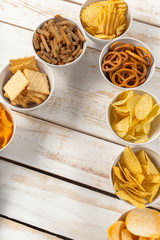 Pretzels in bowls on wooden table from above
