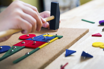 Boy playing with blocks and nails