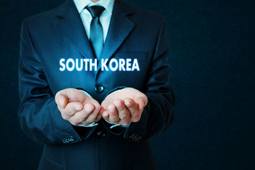 Businessman holding South Korea word