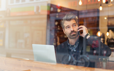 man working on a digital project in a cafe