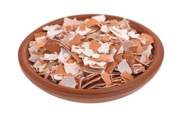 Bowl of crushed and broken egg shells isolated on a white background.