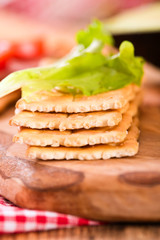 Crackers with ham and avocado. 