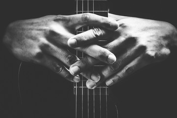musician hands on guitar neck. black and white, music background - obrazy, fototapety, plakaty