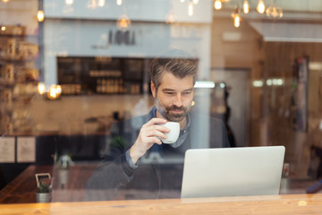 man working with laptop and smartphone