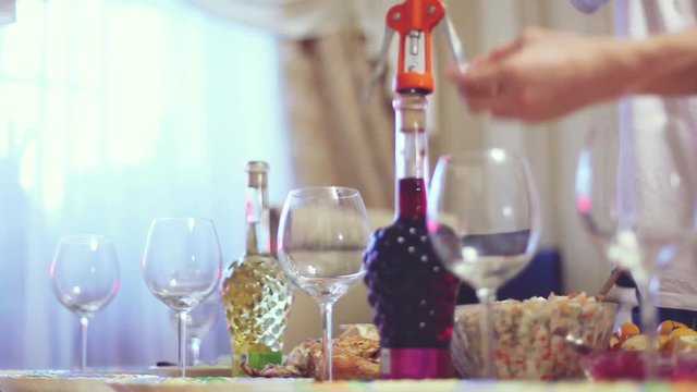 Pouring red wine into glass on served table