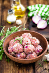 Raw meatballs close-up on wooden background