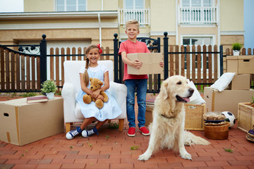 Two happy kids and their pet during relocation