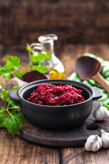 Beetroot salad on wooden background closeup