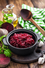 Beetroot salad on wooden background closeup