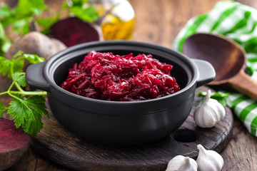 Beetroot salad on wooden background closeup