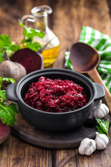 Beetroot salad on wooden background closeup