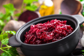 Beetroot salad on wooden background closeup