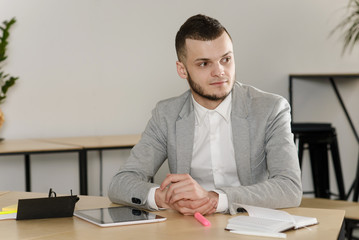 Man in formal wear sitting in the office