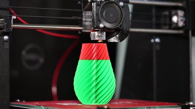 3d printer prints a 3d model of a green-red vase. The video is shot close-up. This video was shot using Canon 5d Mark 3. If you liked this video, rate it, please!