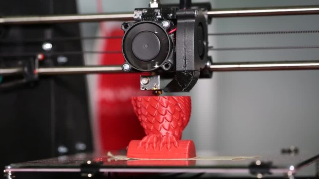 3d printer is typing 3d model of a red owl. The video is shot close-up. This video was shot using Canon 5d Mark 3. If you liked this video, rate it, please!